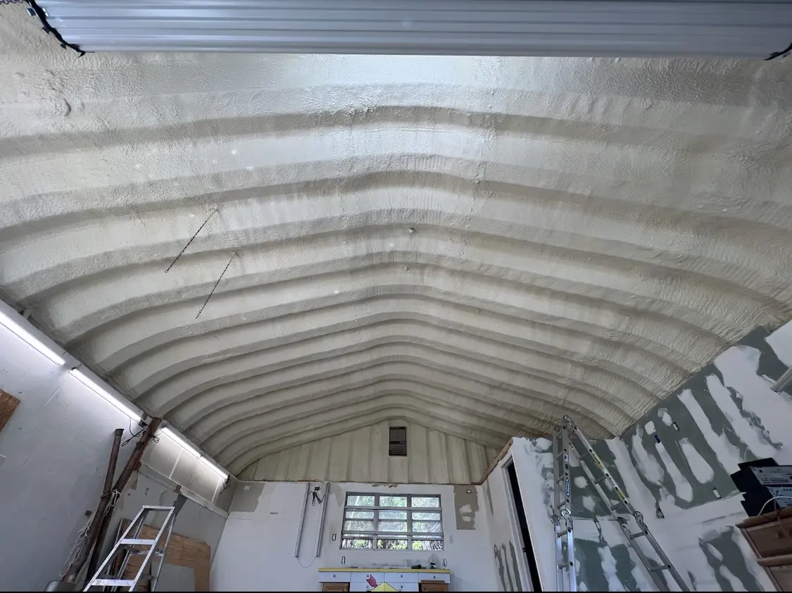 Spray polyurethane foam applied to the underside of a metal roof deck in Sandston